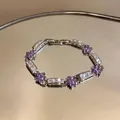 Detailed view of elegant silver bracelet featuring purple flower charms and clear zircon stones. - Purple / Silver