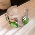 Close-up of a silver metal cuff bracelet featuring large square faceted green gemstones - Square Rhinestone Open Style (HB5715) / Green