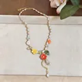 Detailed close-up of a vibrant beaded necklace featuring resin flower and leaf charms - Resin Flower Beaded Necklace / Colorful