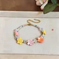 Detailed view of a handmade colorful resin flower beaded bracelet on a neutral tray. - Resin Flower Beaded Bracelet / Colorful
