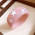 Macro view of pink resin bangle with detailed white star patterns for women jewelry - Light Pink