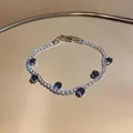 Elegant silver-tone tennis bracelet featuring white zircons and round deep blue crystal accents - Round Tennis Chain / Purple