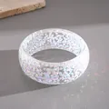 Close-up of a resin bangle featuring irregular holographic geometric flake inclusions - Iridescent White
