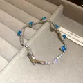 Detailed view of silver-tone tennis bracelet with blue and clear sparkling stones - Silver-Blue