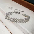Detailed view of a handmade silver mesh bracelet with clear crystal beads and adjustable clasp. - White Beads / Silver