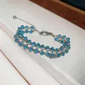 Detailed view of a handcrafted blue beaded hollow bracelet with a silver chain mesh. - Blue Beaded / Silver
