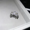Close-up detail of a sparkling silver flower open ring featuring yellow and clear zircon stones - US 6 Ring