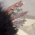 Detailed close-up of elegant French vintage pearl beaded tassel drop earrings for women - Long Tassel / Silver
