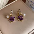Detailed macro view of French style purple heart clover earrings with white pearls. - Clover Flower Pearl Style / Gold-Purple