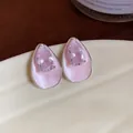 Close-up detail of pink zircon and enamel teardrop stud earrings with a silver finish - Waterdrop Studs / Pink