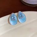 Macro detail of light blue enamel water drop earrings with sparkling teardrop zircon - Waterdrop Studs / Blue
