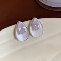 Detailed view of elegant silver teardrop earrings featuring white enamel and zircon stones - Waterdrop Studs / White