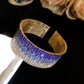 Close-up detail of gradient blue and white rhinestone multi-layer stretch cuff bracelet - Gold Tone Dark Blue Gradient