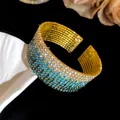 Close-up of a multi-layer gradient rhinestone elastic cuff bracelet in gold finish - Gold Tone Sky Blue Gradient