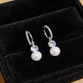 Elegant silver-colored C-shaped zircon earrings with white pearl drops in black jewelry box - C-Shaped Drop Style / Silver
