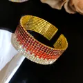 Detail shot of a luxury multi-layer rhinestone stretch bangle with a red gradient - Gold Tone Burgundy Red White Gradient