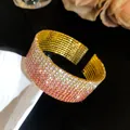 Close-up of luxury gradient pink rhinestone multi-layer cuff bracelet with gold base - Gold Pink Gradient