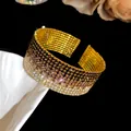 Close-up of luxury gradient rhinestone multi-layer stretch open bangle - Gold Tone Purple Gradient