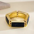 Detail view of a vintage gold-toned bracelet with black rectangular resin inlays - Western Retro Rectangle Patchwork (HB6097) / Gold-Blue