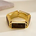 Detail shot showing the polished gold finish and marble resin pattern of this stretch bracelet - Western Retro Rectangle Patchwork (HB6097) / Gold Brown