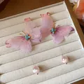 Close-up of pink chiffon butterfly earrings with blue crystals and pearls in a jewelry tray - Butterfly Pearl Long Style / Pink