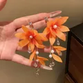 Elegant orange fabric flower drop earrings with pearls and crystal tassels for women - Orange