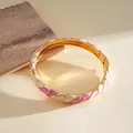 Detalle de brazalete dorado con ondas y esmalte rosa y blanco de colores vibrantes. - Blanco-Rosa