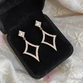 Elegant 18k gold-plated star earrings with zirconia displayed in a black velvet box - Earrings / Gold