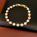 Detailed view of an 18k gold plated bracelet with sparkling round cubic zirconia stones - Gold White