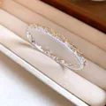 Detail showing intricate lace texture and pave-set crystals on a silver bangle - Style 3