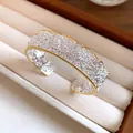 Detailed view of a silver lace texture cuff bracelet with crystals and gold trim. - Style 5