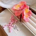 Detailed view of pink fabric flower hair clip with elegant dangling flower tassels - New Chinese Fabric Flower Lily Tassel (HH9910) / Pink Series with Green (Single Piece)