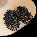 Detailed macro shot of black rhinestone mesh fringe earrings with silver needle posts - Gunmetal