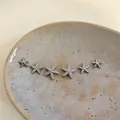 Detail view of silver-tone starfish stud earrings set with sparkling zircon inlays. - 6# Starfish Style