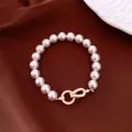 Detail view of a vintage pearl bracelet with a sparkling zircon-encrusted gold clasp. - Gold-Light Pink