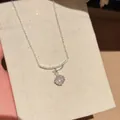 Macro detail of a sparkling zircon necklace with a star charm on a beige fabric card - Star Moon Necklace (HN12690) / Silver-White