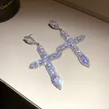 Detailed view of sparkling cubic zirconia cross drop earrings featuring silver needle posts - Classic Cross Style (48#)
