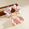 Close-up detail of pink and white enamel flower drop earrings with gold-tone stems - Steel Post Style (HE34222) / Pink