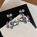 Detailed macro view of cute elephant stud earrings with pink bows and blue zircons - Cartoon Elephant Bowknot Style / Silver-Pink-Blue