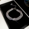 Primer plano de una pulsera elegante de cuatro hileras con pedrería brillante - 35# Pulsera