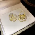Detailed view of gold flower basket earrings with cream resin roses and rhinestones. - Flower Basket Style / Gold-Green