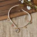 Close-up of pearl necklace with crystal heart pendant and golden butterfly charms - Heart Butterfly Pendant Style / 46cm / White-Pink