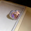 Detailed macro view of a sparkling heart-shaped pink zircon ring with elegant halo setting - Pink