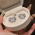 Dettaglio macro di orecchini a forma di orso in resina e zircone in una scatola bianca - Un Paio / Bianco