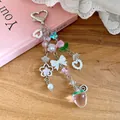 Detailed close-up view of pink strawberry charm and white bow on sweet beaded accessory - Silver Red Pink