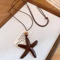 Close-up of a vintage starfish resin pendant with wooden beads and a brown leather cord - Grain Starfish (Style 4)
