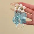 Close-up of blue chiffon flower tassel earrings with intricate bead decorations - Silver Earring Post Style / Blue