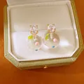 Close-up of 18k gold plated stud earrings with clear zircon and colorful glass sphere - Round Polka Dot Ball Style (HE34206) / Gold-White Polka Dot