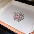 Close-up of elegant silver-tone ring with cushion-cut pink cubic zirconia center stone - Square Zirconia Cluster Style (HR3604) / Adjustable Open / Silver-Pink