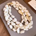 French retro multi-layer acrylic bead necklace with elegant gold-tone OT clasp detail. - White